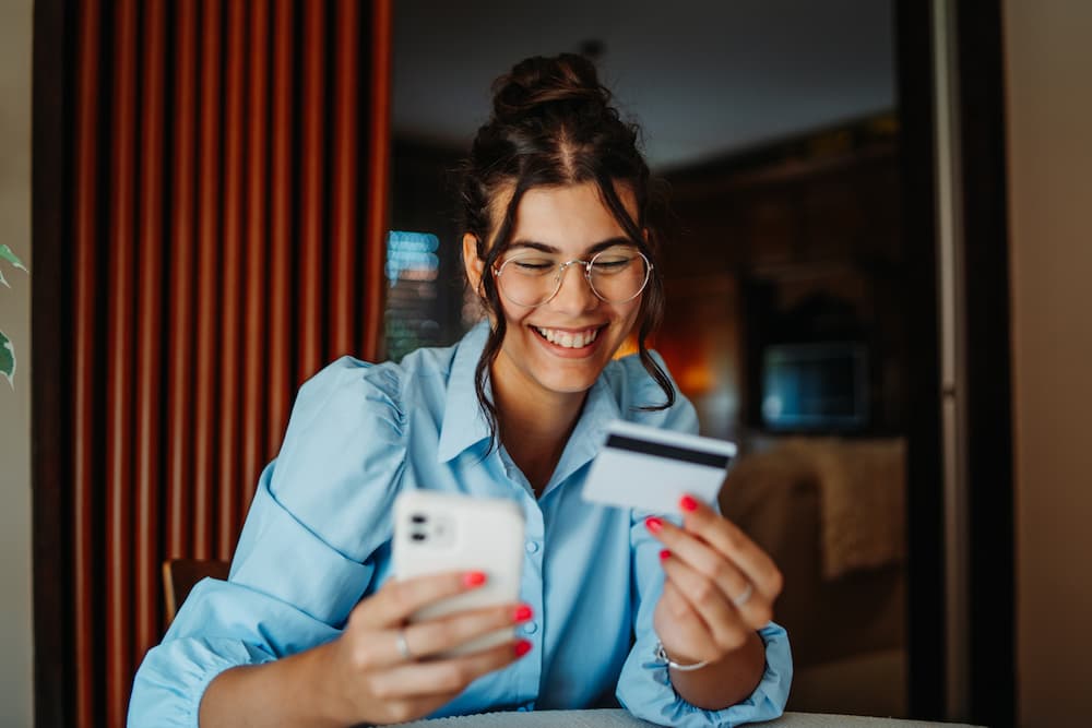 Personal Checking Accounts | A person entering card information into a phone